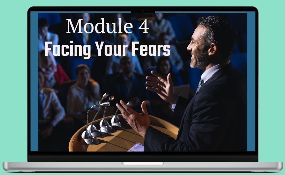 Man speaking to an audience because he has overcome his fear of public speaking